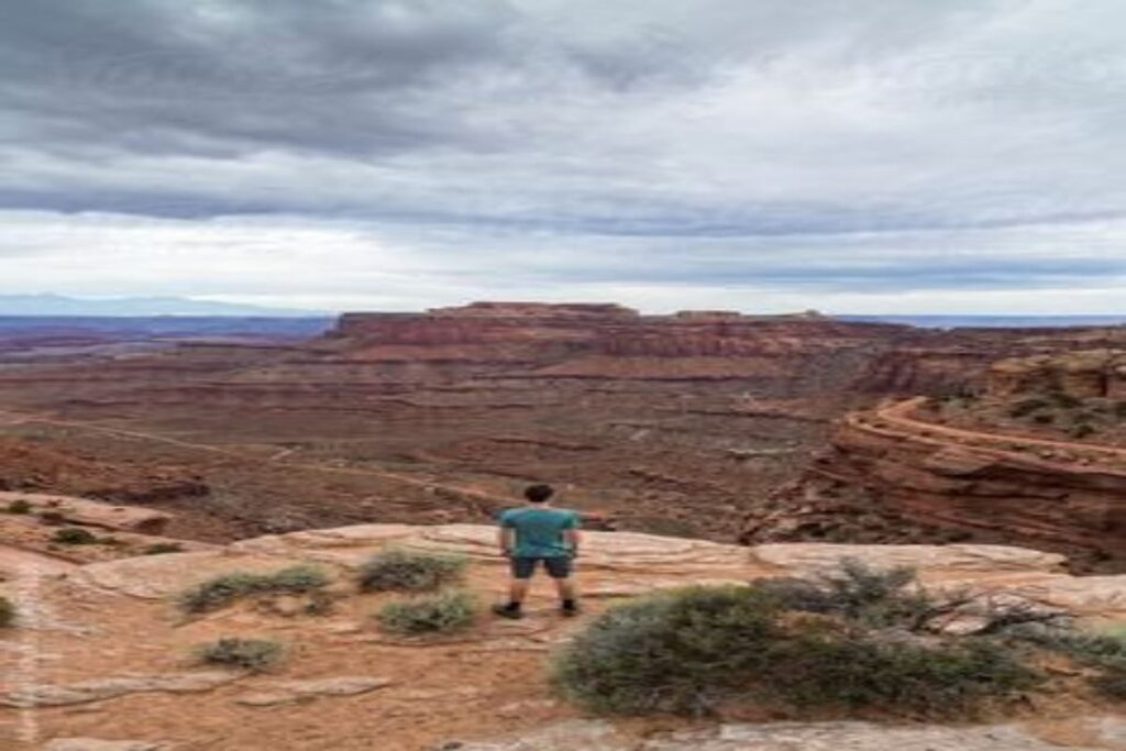 A Boy Standing on a Cliff