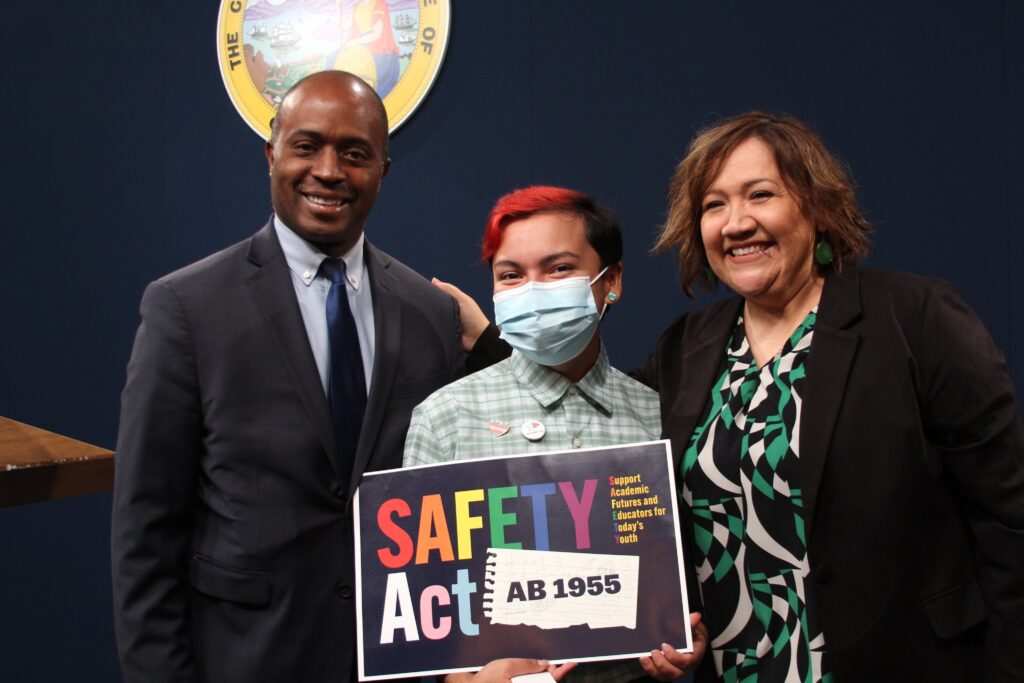 A Picture of Three People With a Placard