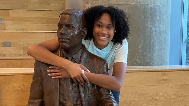 A Picture of Deanna Yancey and Her Grandfather's Statue