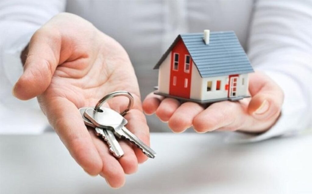 A Picture of a Key and House on a Palm