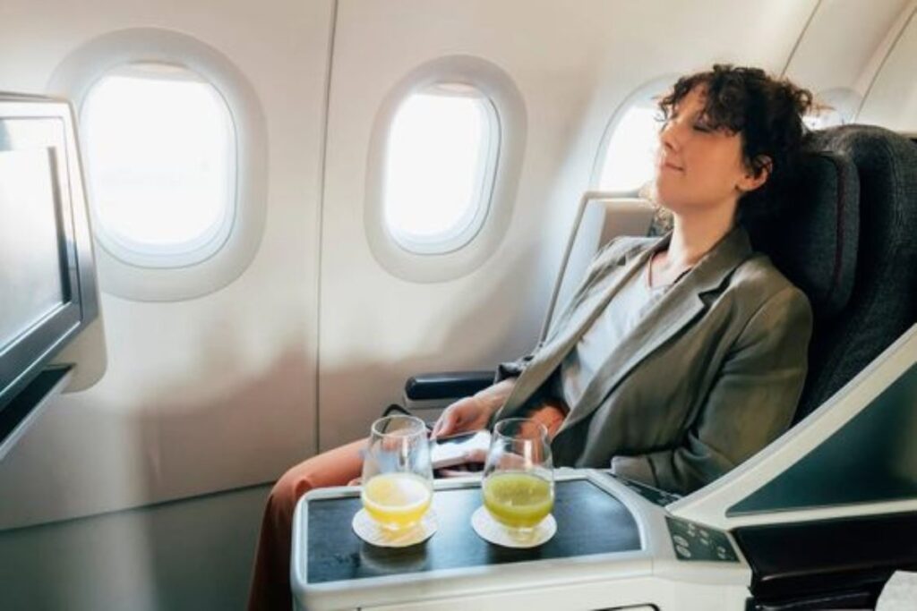 A picture of a lady sleeping after drinking on the plane