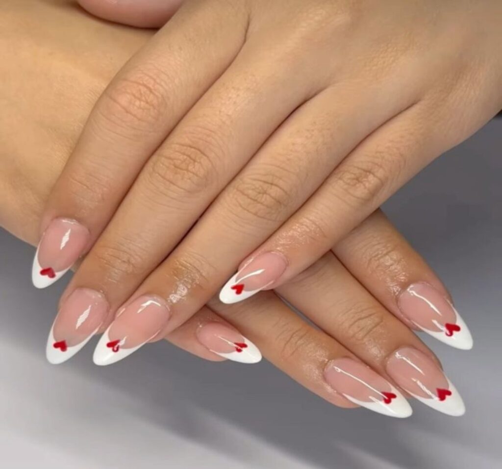 A picture showing Scalloped French Heart white nail looks