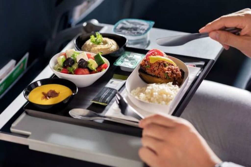 A picture showing someone eating in the plane