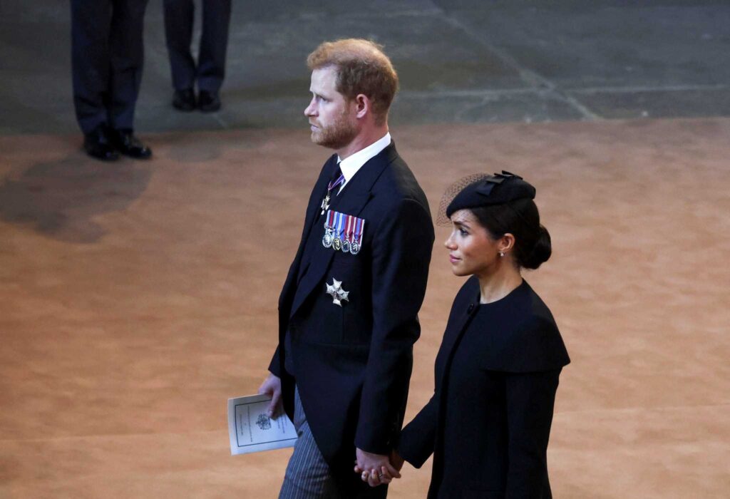 The Prince and his wife striding hand in hand