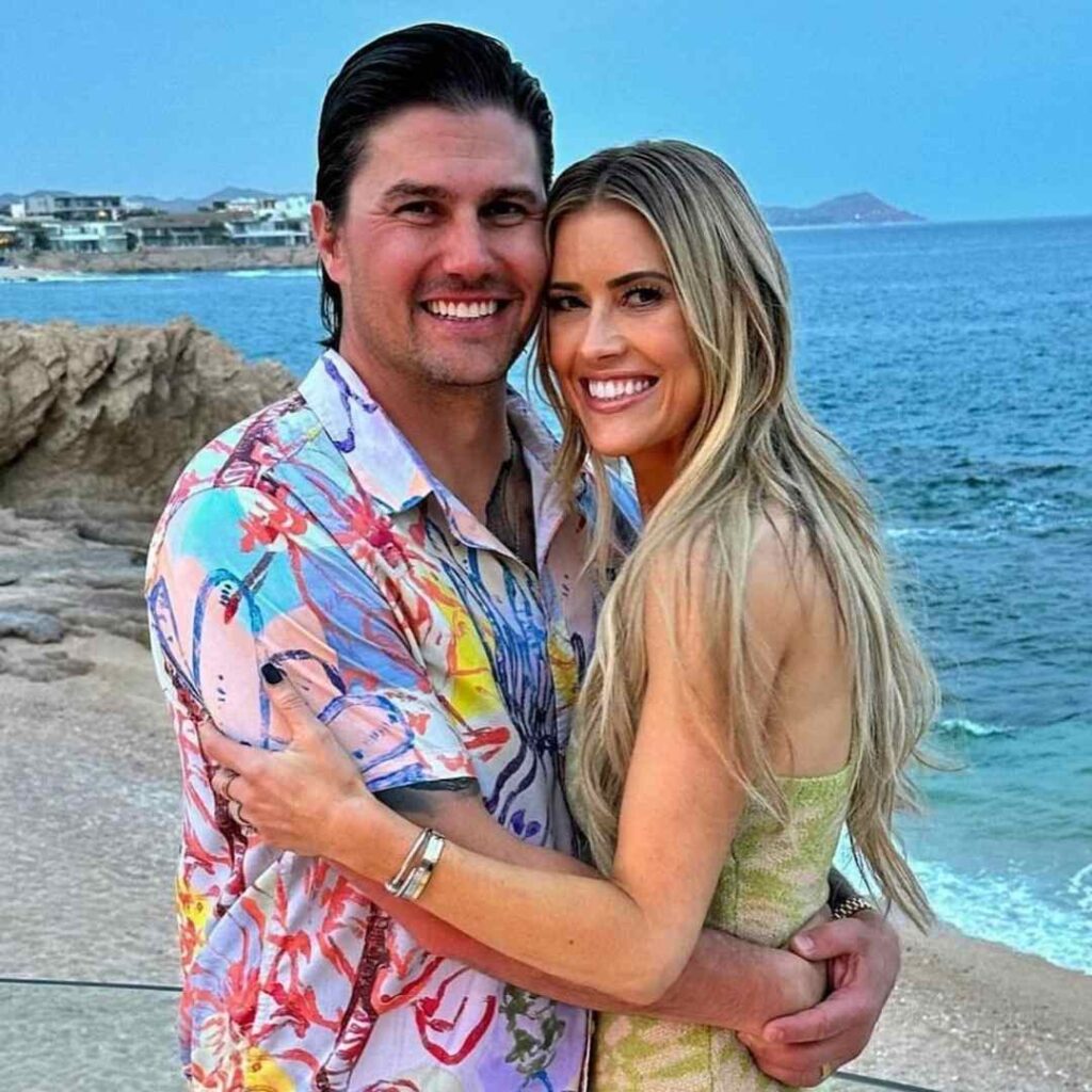 Joshua and Christina Hall pictured on a beach