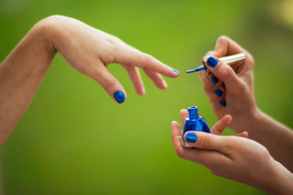 A Picture of a Woman Painting Her Nails