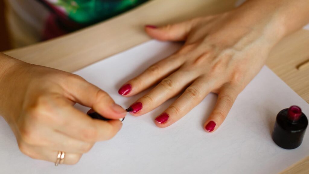 A Picture of a Woman Applying Nail Polish