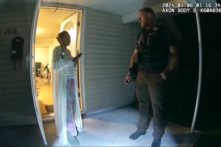 A scene from the bodycam footage showing Sonya talking to cops on her porch