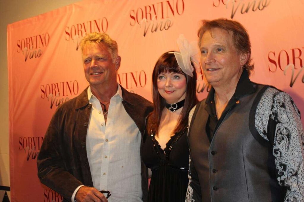 Rex Smith & John Schneider posing with Dee Dee Sorvino