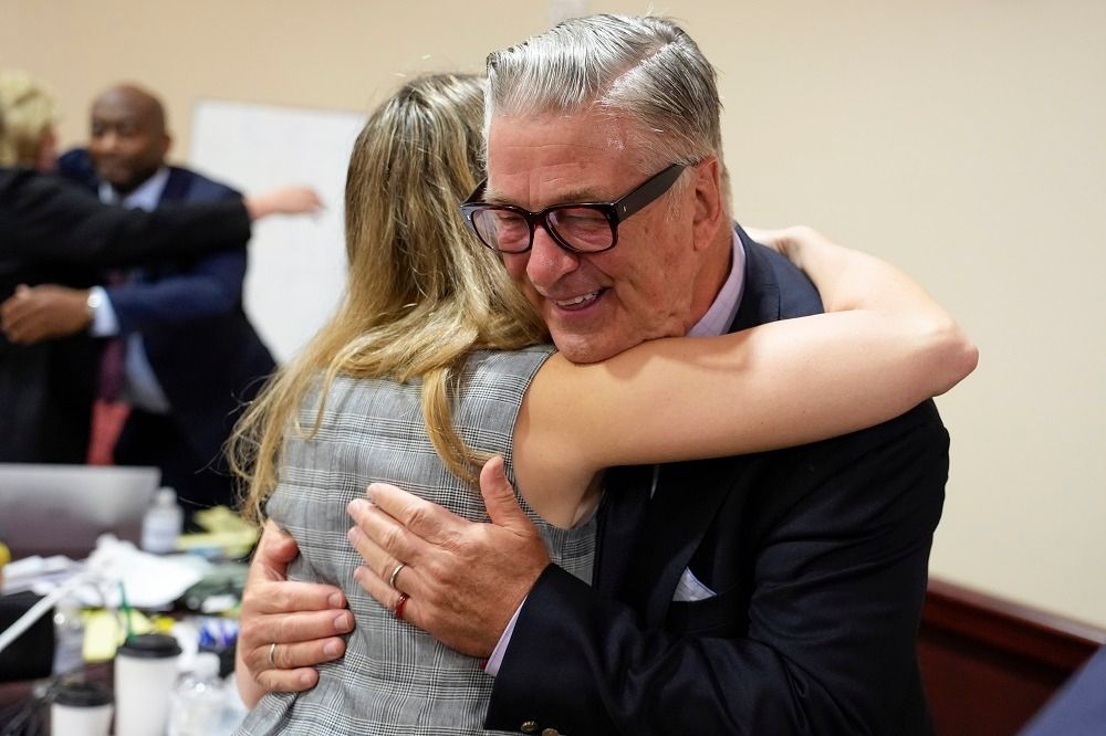 Alec Baldwin hugging a girl in court