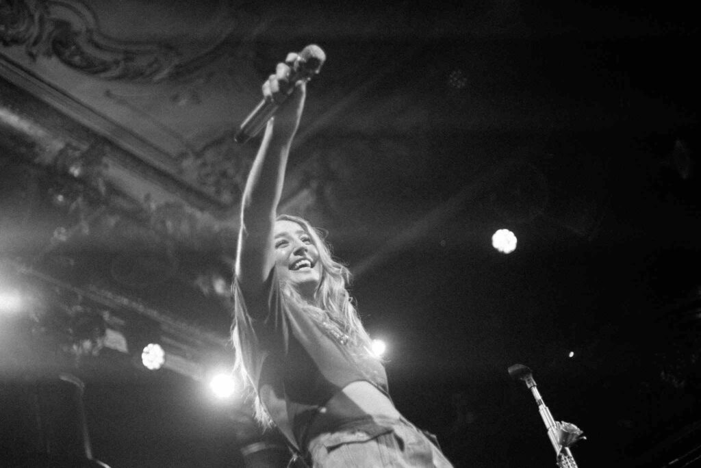 A black and white shot of Ingrid Andress during a performance 