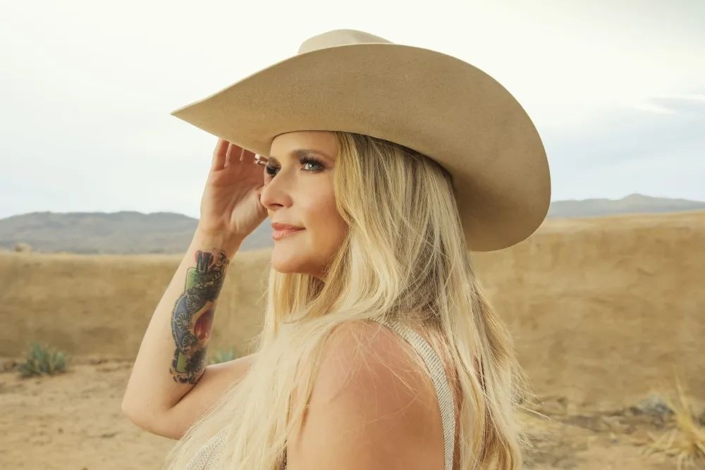 A headshot of Lambert wearing a cowboy hat