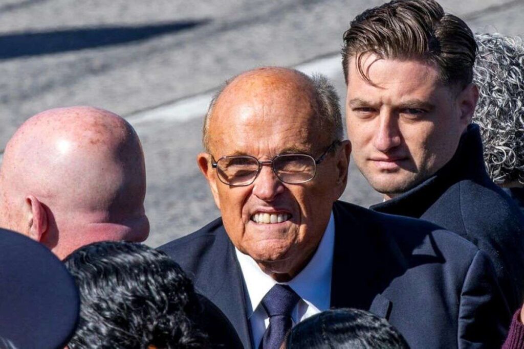 A headshot of Rudy Giuliani with a scowl on his face