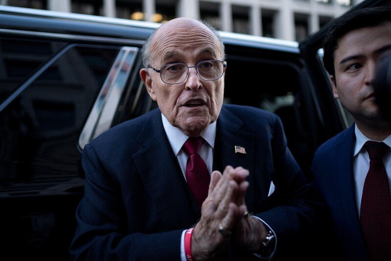 Rudy Giuliani with his hands joined as of in supplication