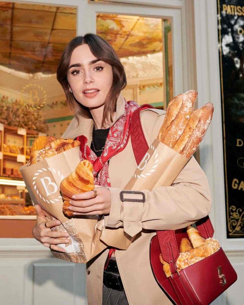 Lily Collins holding food