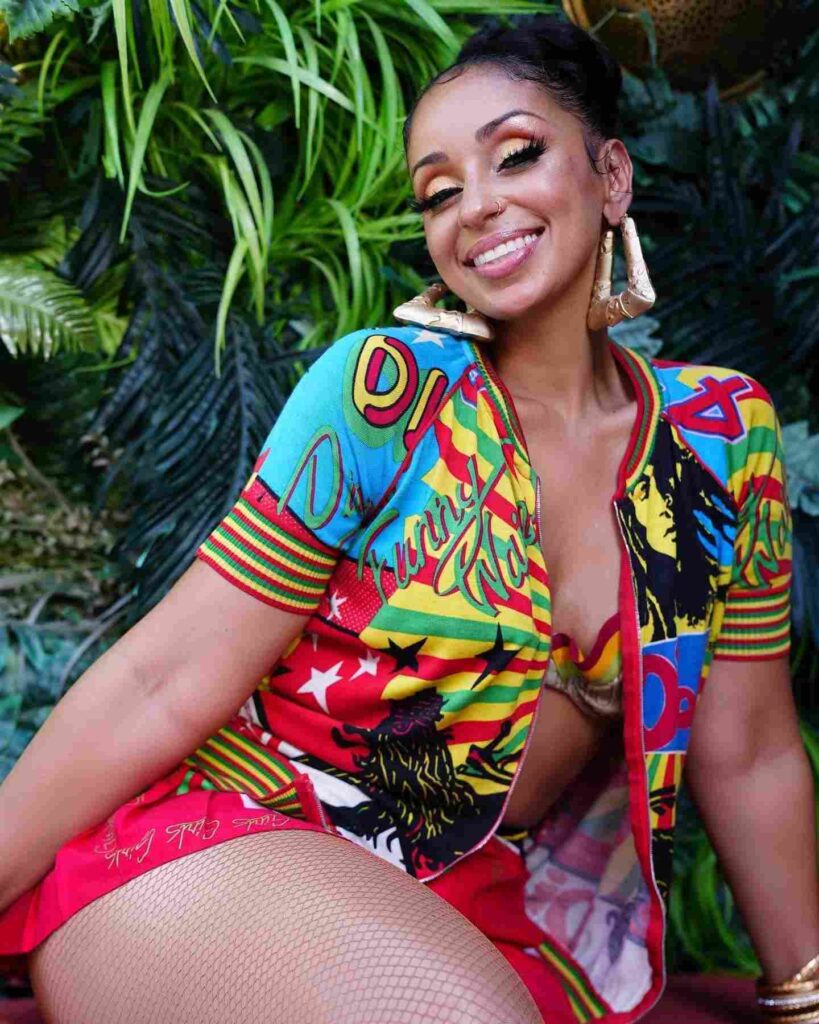 Mya in a colourful outfit