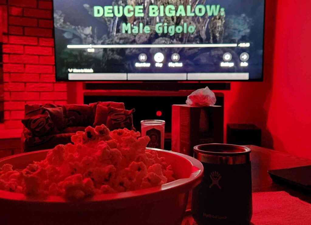 A bowl of popcorn in a room illuminated by a red light