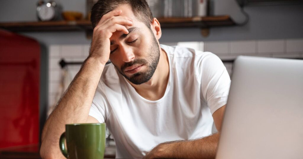 A Picture of a Man Experiencing Brain Fatigue While Working