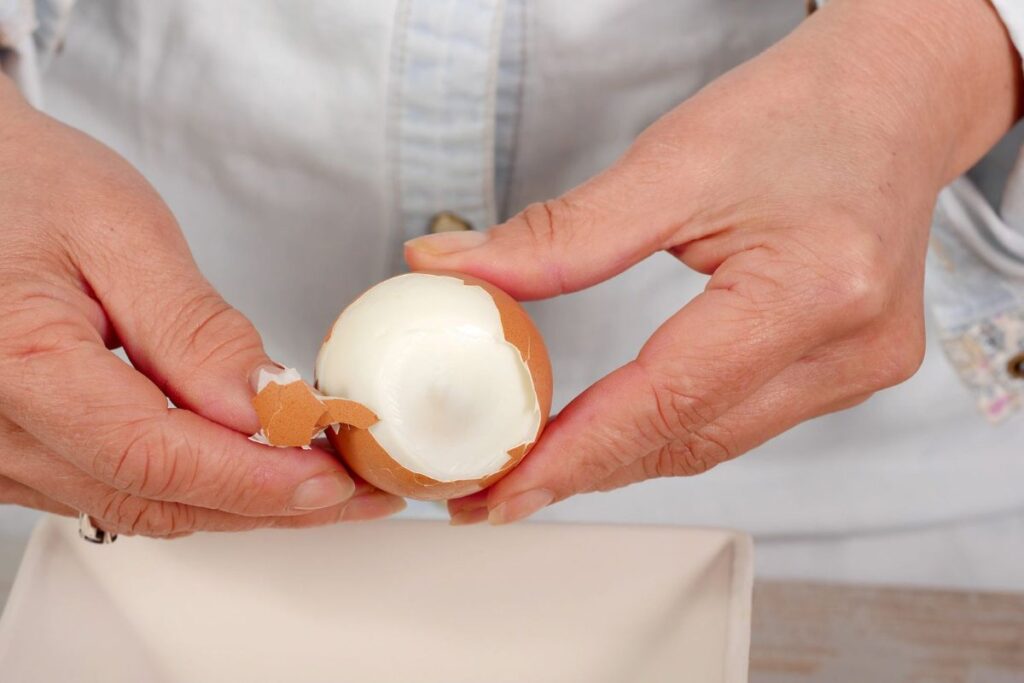 A Picture of Someone Peeling Boiled Eggs