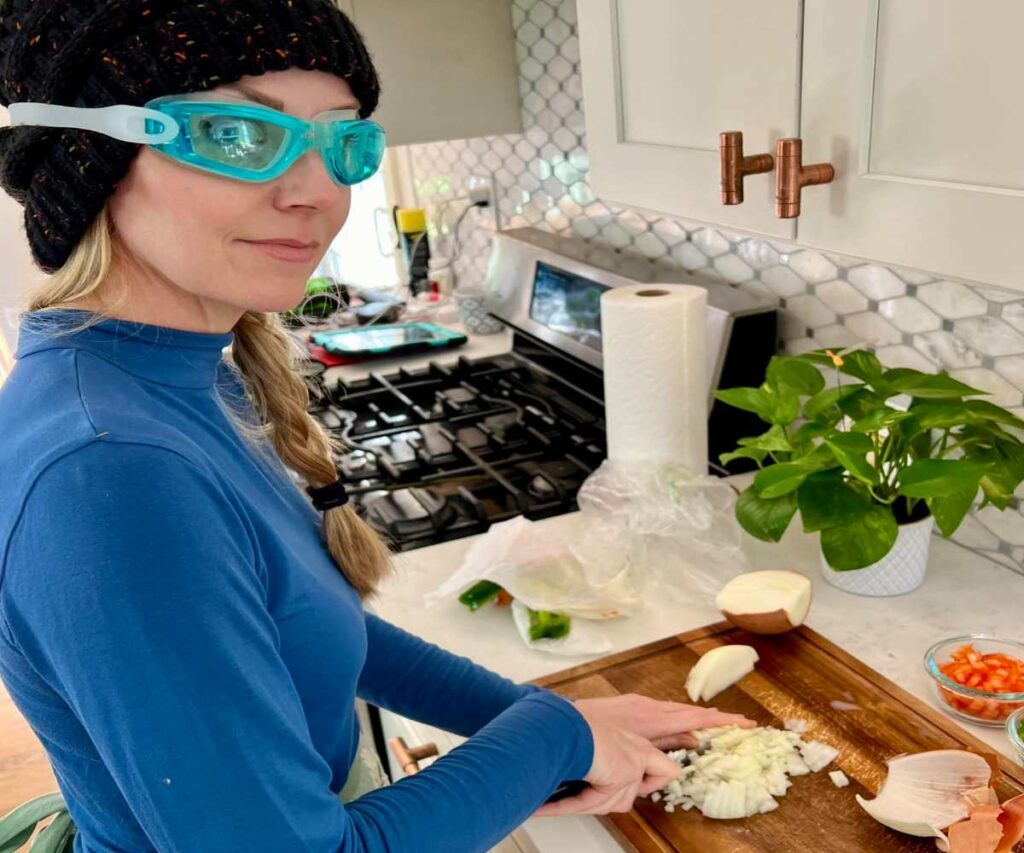 A Picture of a Woman Cutting Onions