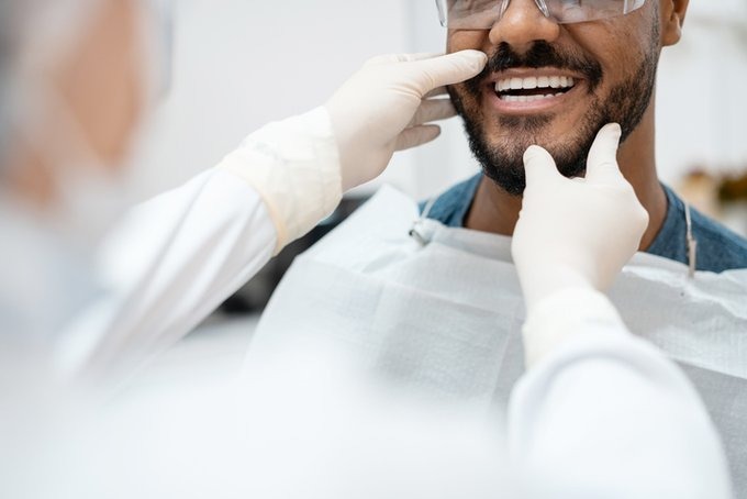 A man getting his teeth checked at the dentists'