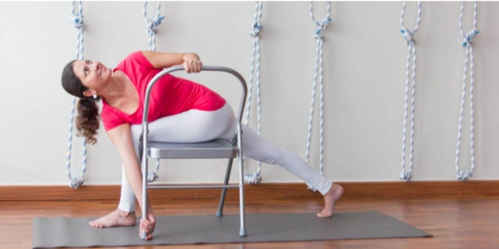 A woman practicing chair yoga