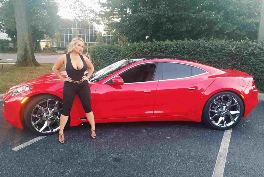 Ice-T's wife Coco posing with a red exotic car