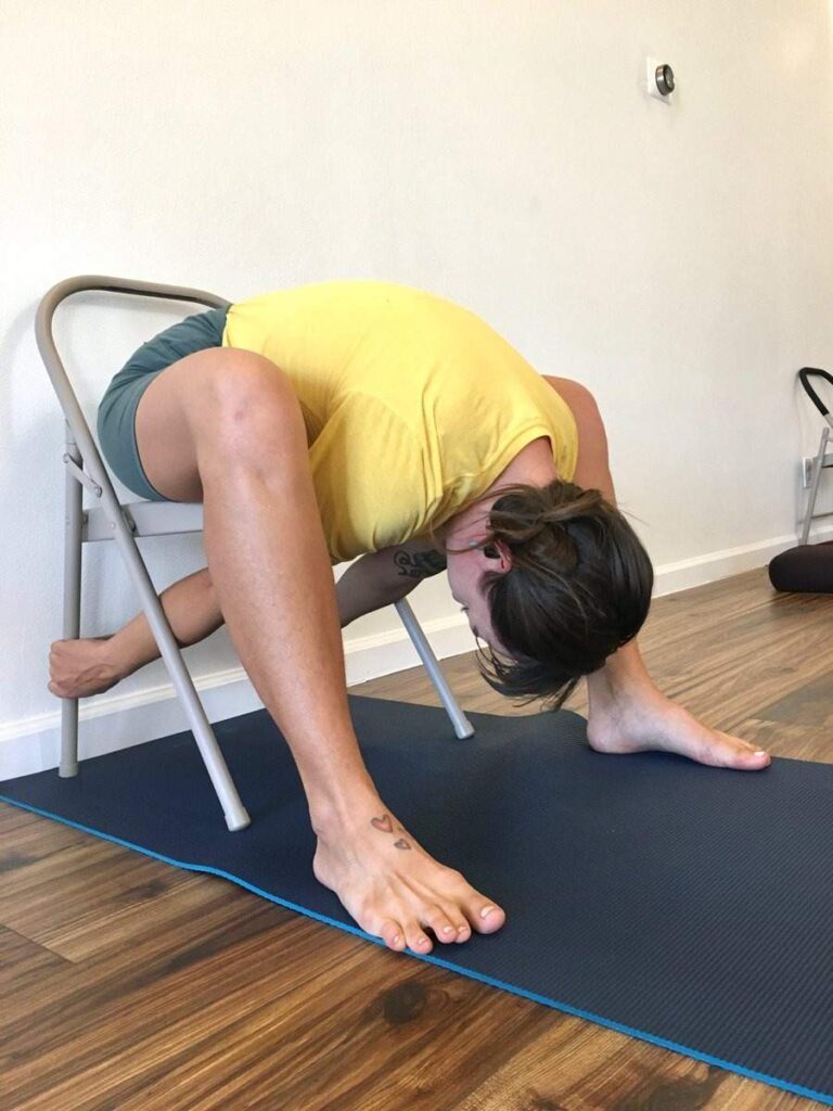 A woman practicing chair yoga