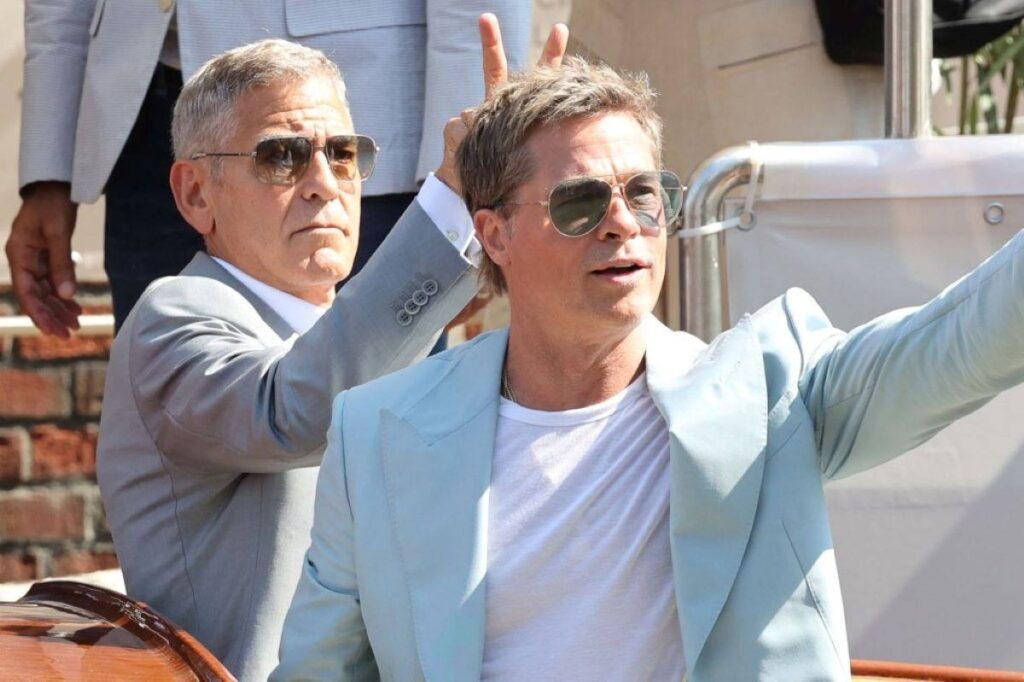 George Clooney and Brad Pitt fooling around at the Venice Film Festival