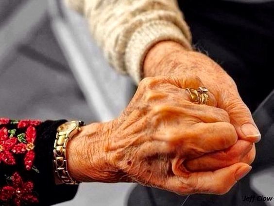 An old couple holding hands