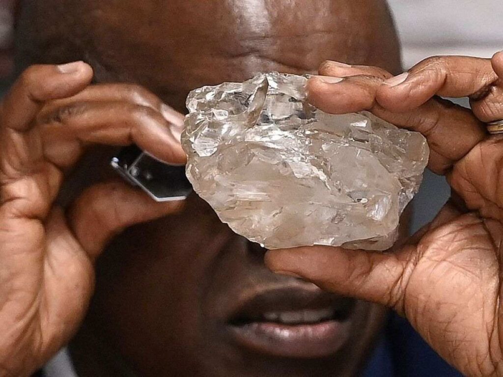 An official admiring the 2,492-carat Diamond up close