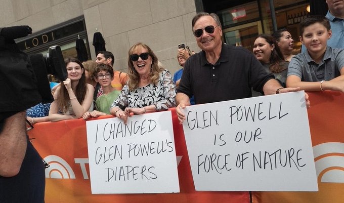 Glen Powell's parents cheering him on and shading at the same time