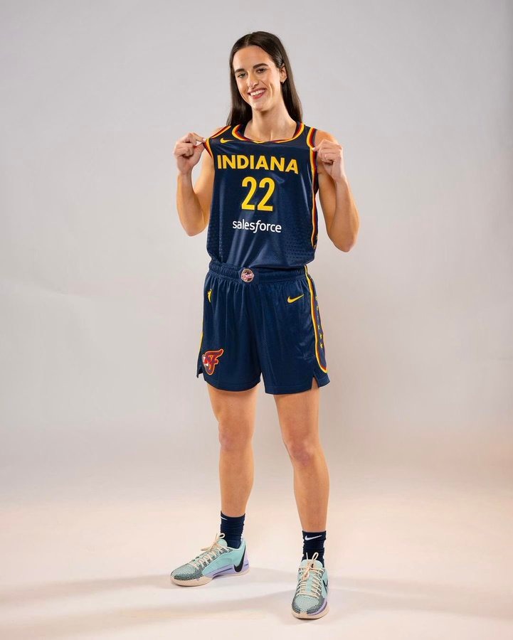 Caitlin Clark showing off her jersey