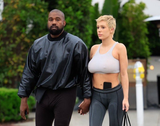 Kanye West and Bianca Censori holding hands on a stroll