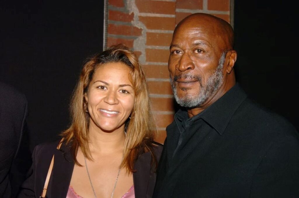 John Amos' daughter posing with him