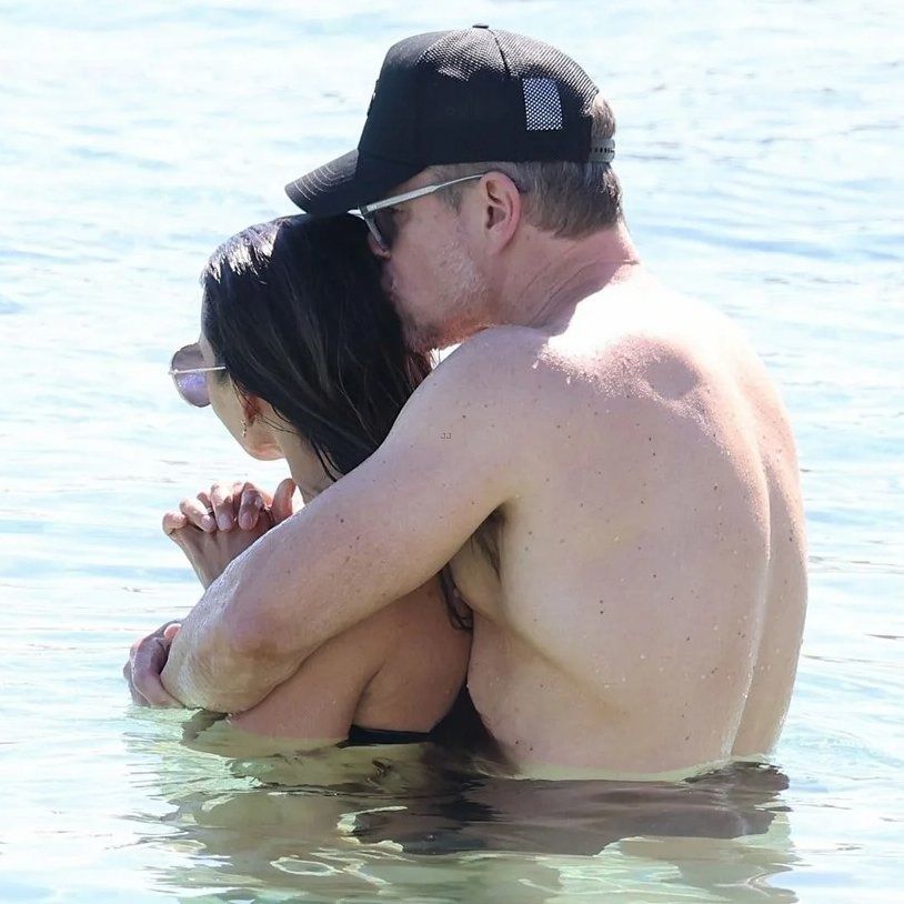 Matt Damon giving his bikini-clad wife a kiss in the ocean