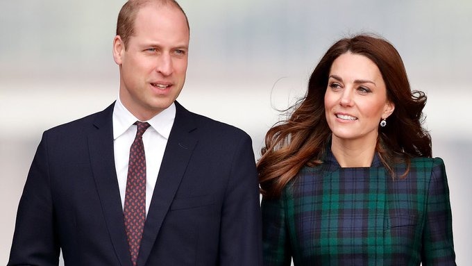 Prince William standing next to his wife