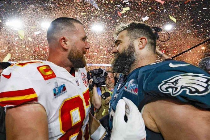 Travis and Jason Kelce facing each other dressed in their NFL jersey